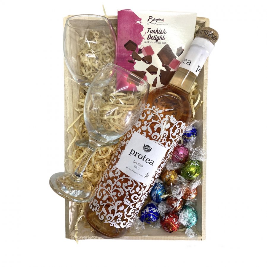 Rose wine with glasses and chocolates